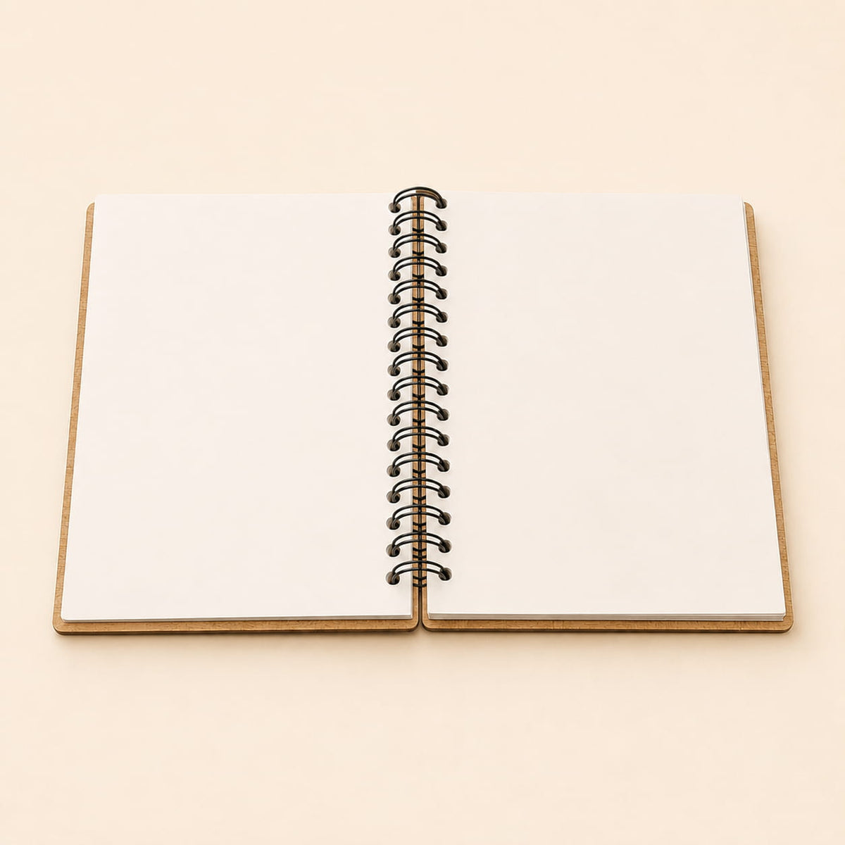 An open blank spiral notebook with white pages and a black metal coil binding, set against a solid light beige background.
