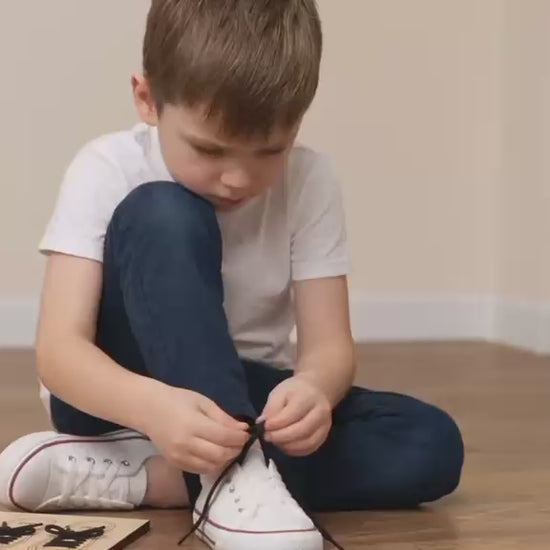 Child practising shoe tying using the BLASCA learning board