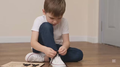 Child practising shoe tying using the BLASCA learning board